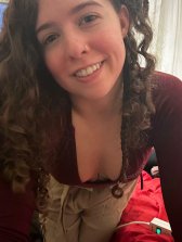 Woman showing off deep cleavage in tight low-cut top