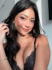 Petite Latina woman posing topless showing her natural small breasts