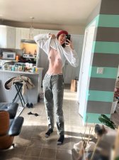 Tall petite woman posing nude showing off her slender adult body