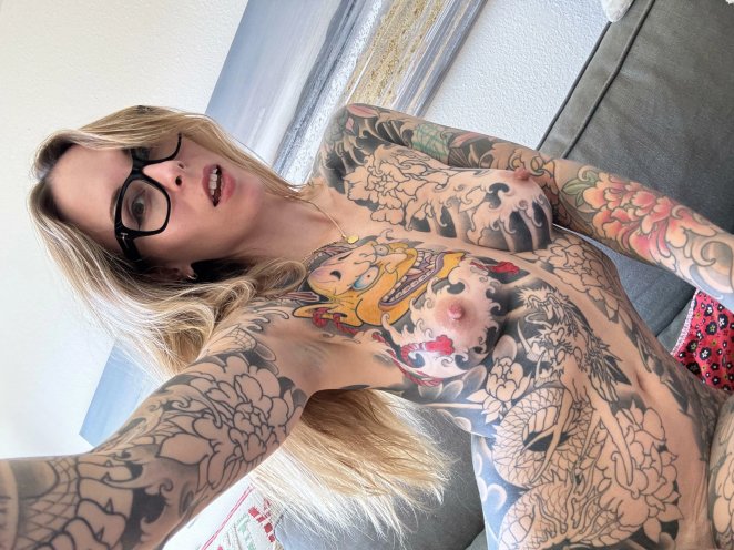 Inked Art and Bold Frames: Exploring the Intersection of Tattoos and Thick Glasses