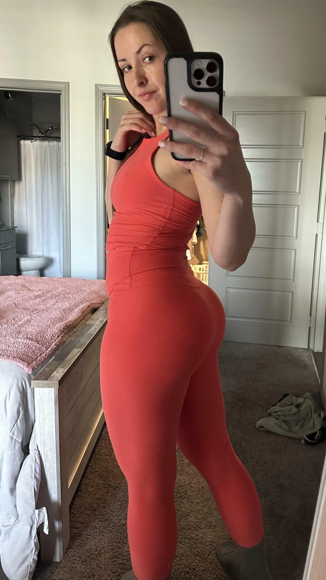 Woman posing confidently in tight yoga pants showing off her curves