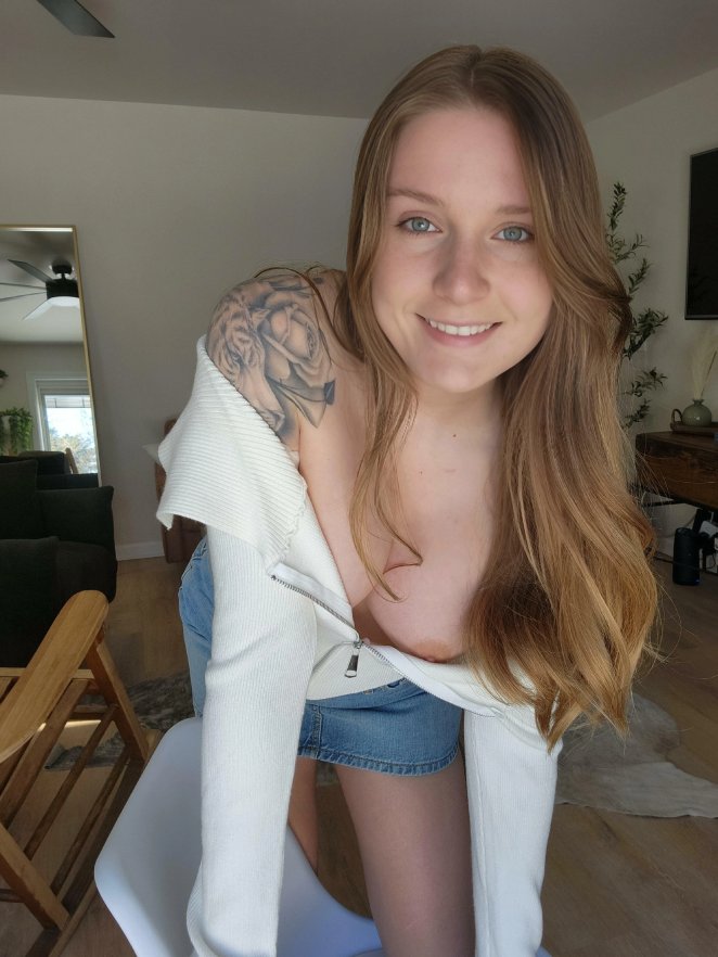 Grinning as you catch a glimpse down my top