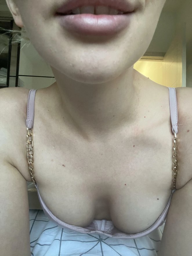 Woman displaying deep cleavage in low cut top, inviting touch