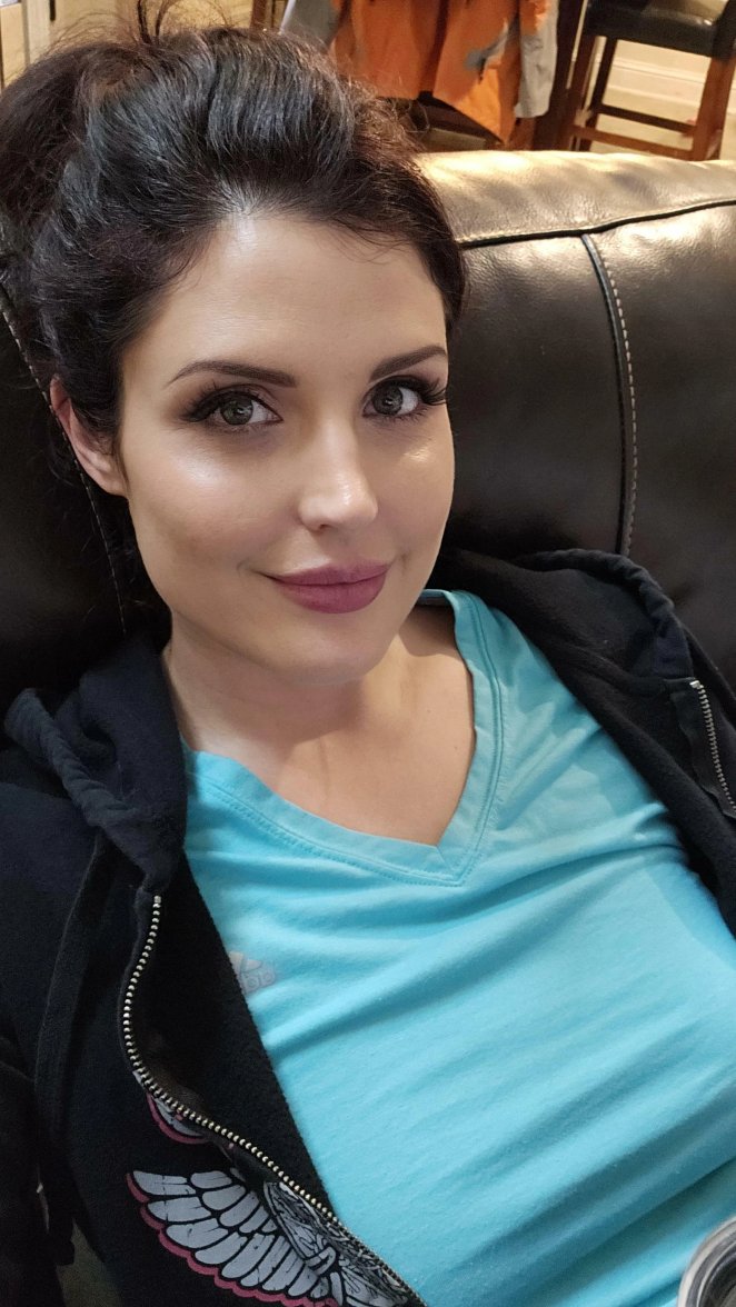 Smiling mature woman taking a casual clothed selfie in everyday attire