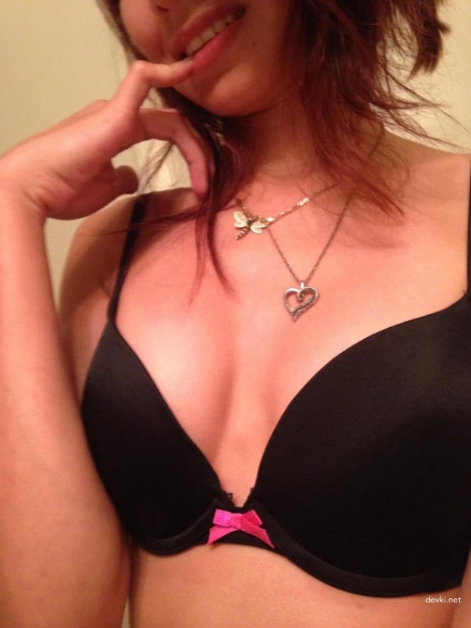 She poses naked and caresses the front with her fingers