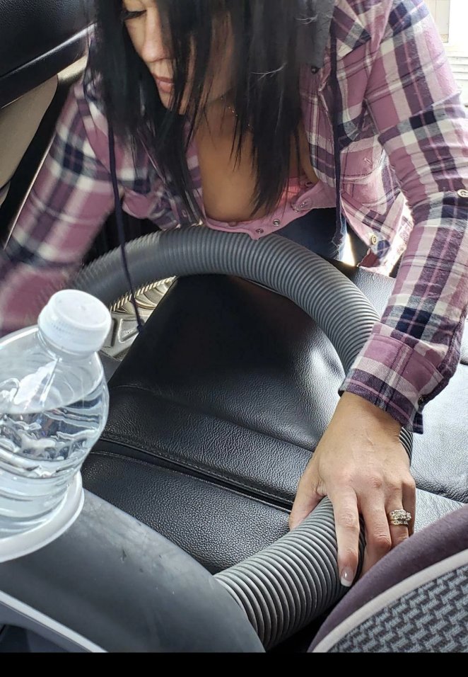 Cleaning out my car with a vacuum.