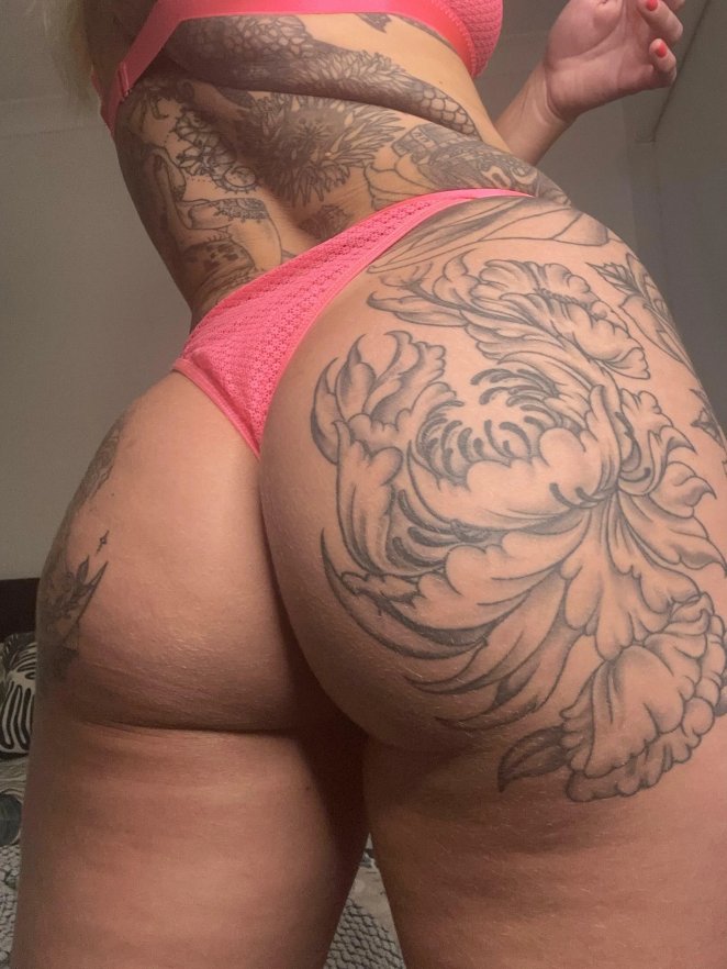 Person wearing pink underwear showing off their bare backside to camera