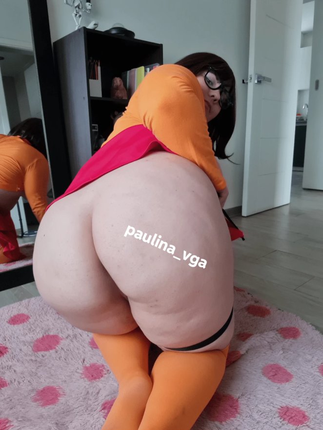 Curvy woman lying in bed with an inviting and playful expression