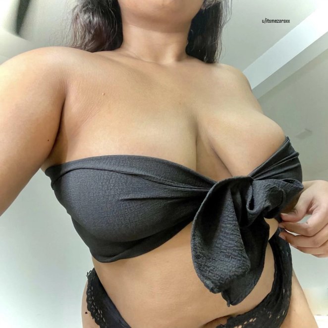 Woman relaxing at home in a low cut top showing cleavage