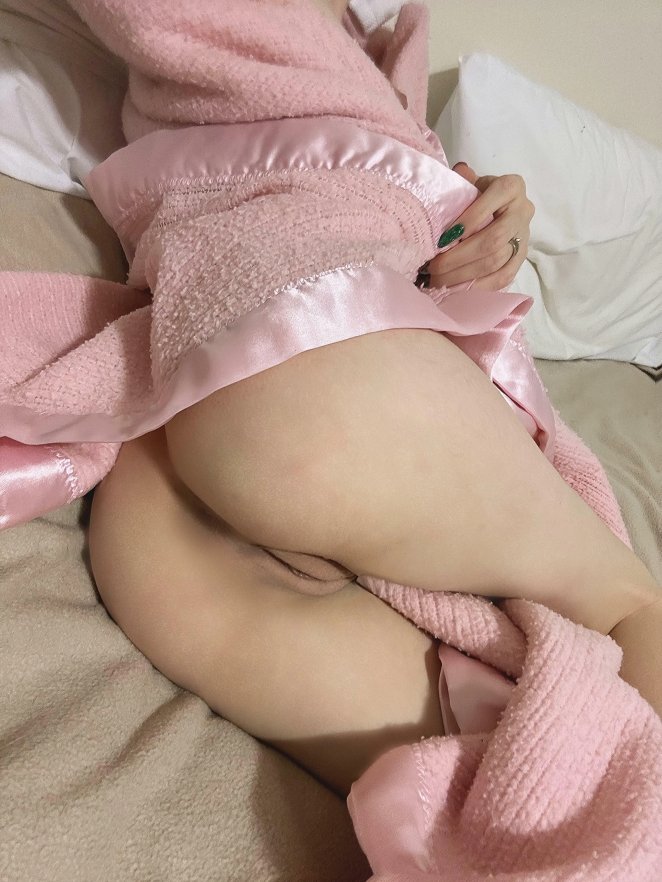 Petite woman posing with a peek of something extra subtly visible