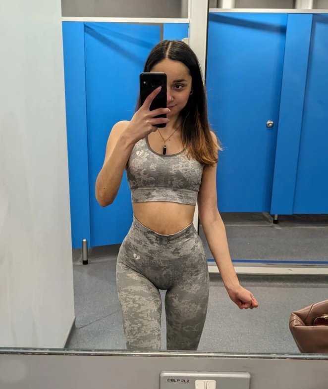 Petite nude woman posing to show off her small slender figure