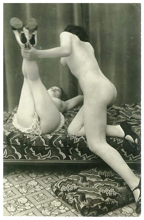 1920s lesbian lifting her lover's legs.