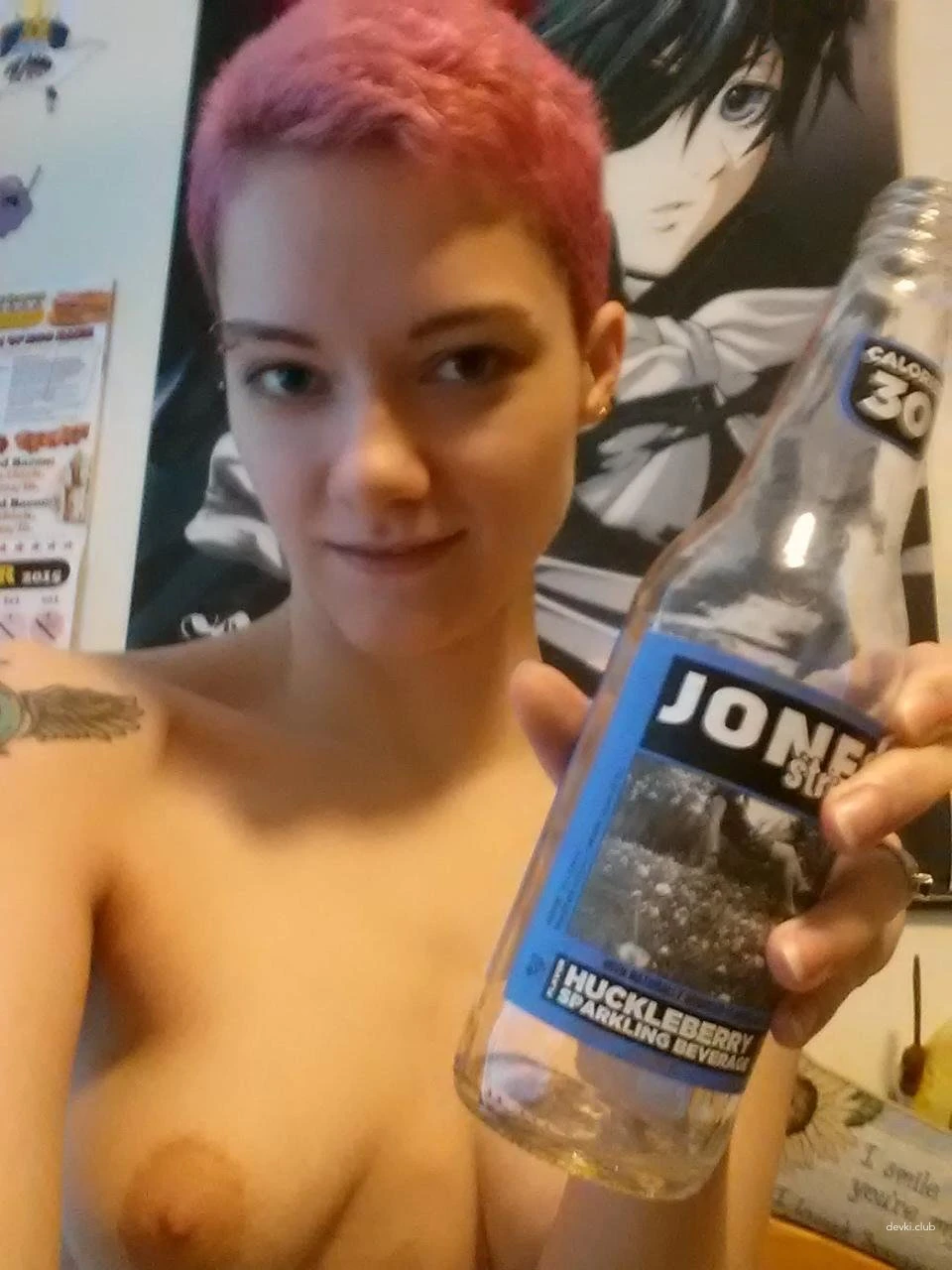 The girl fucks herself with a bottle