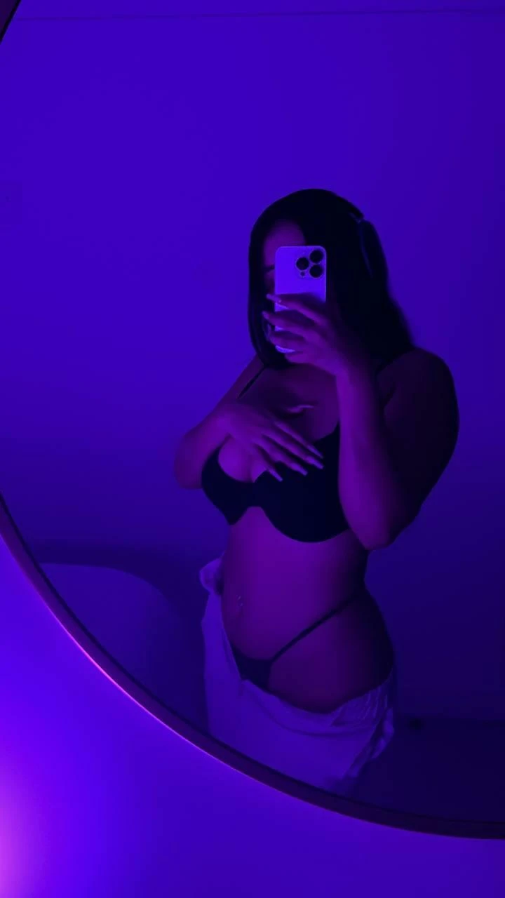 Asian woman posing confidently, showing off her figure for the camera