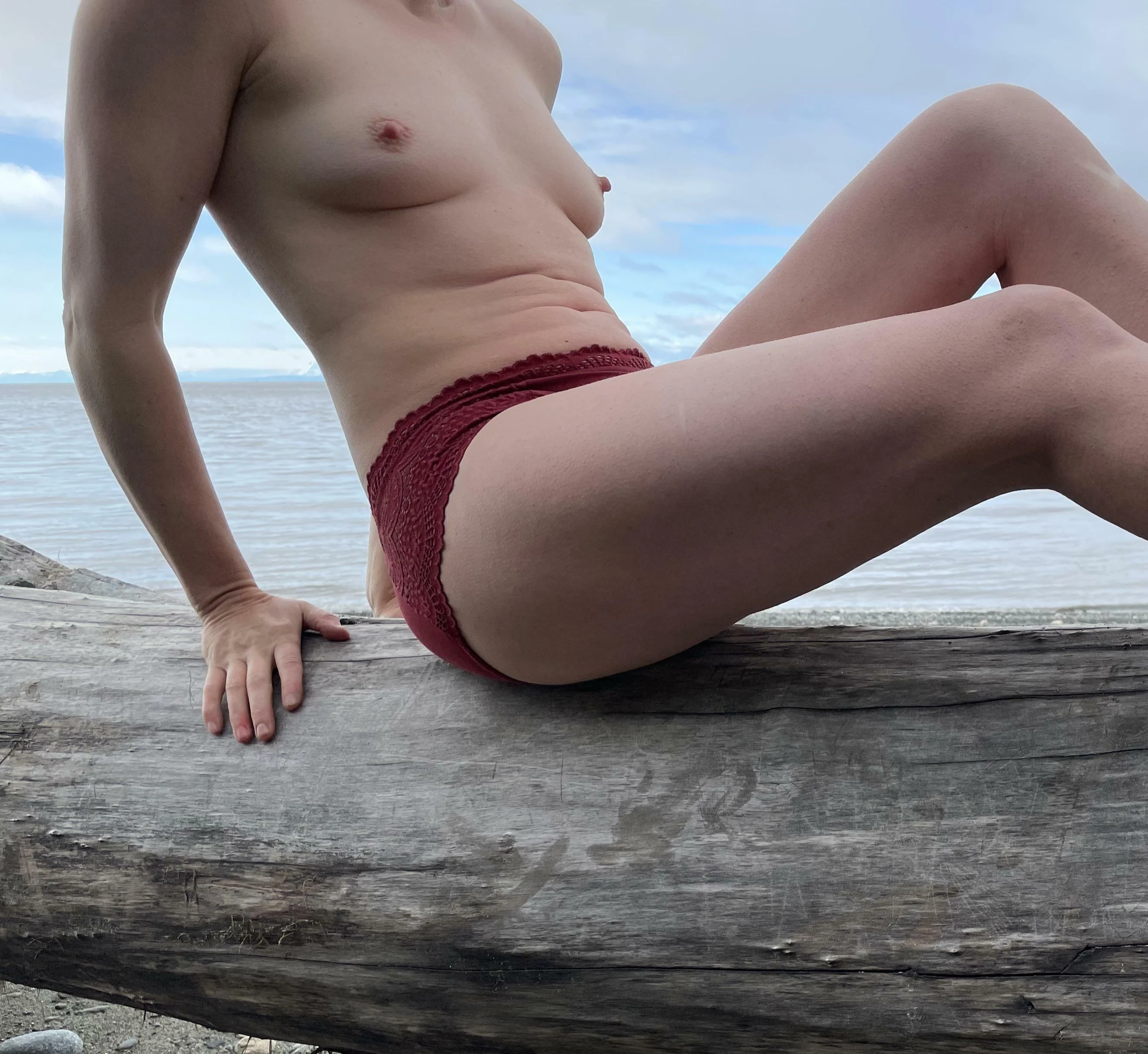 Pale woman with fair skin posing outdoors at a sunny beach