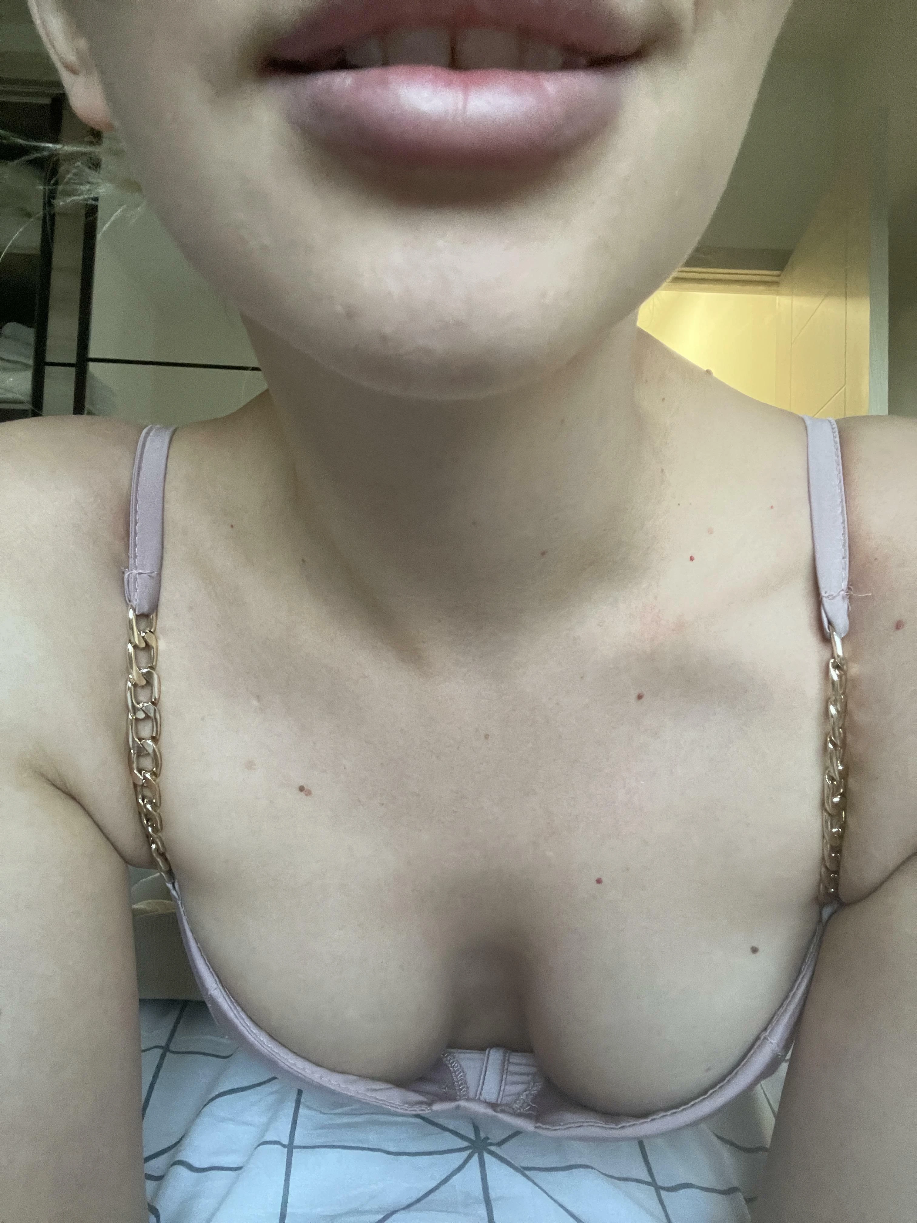 Woman displaying deep cleavage in low cut top, inviting touch