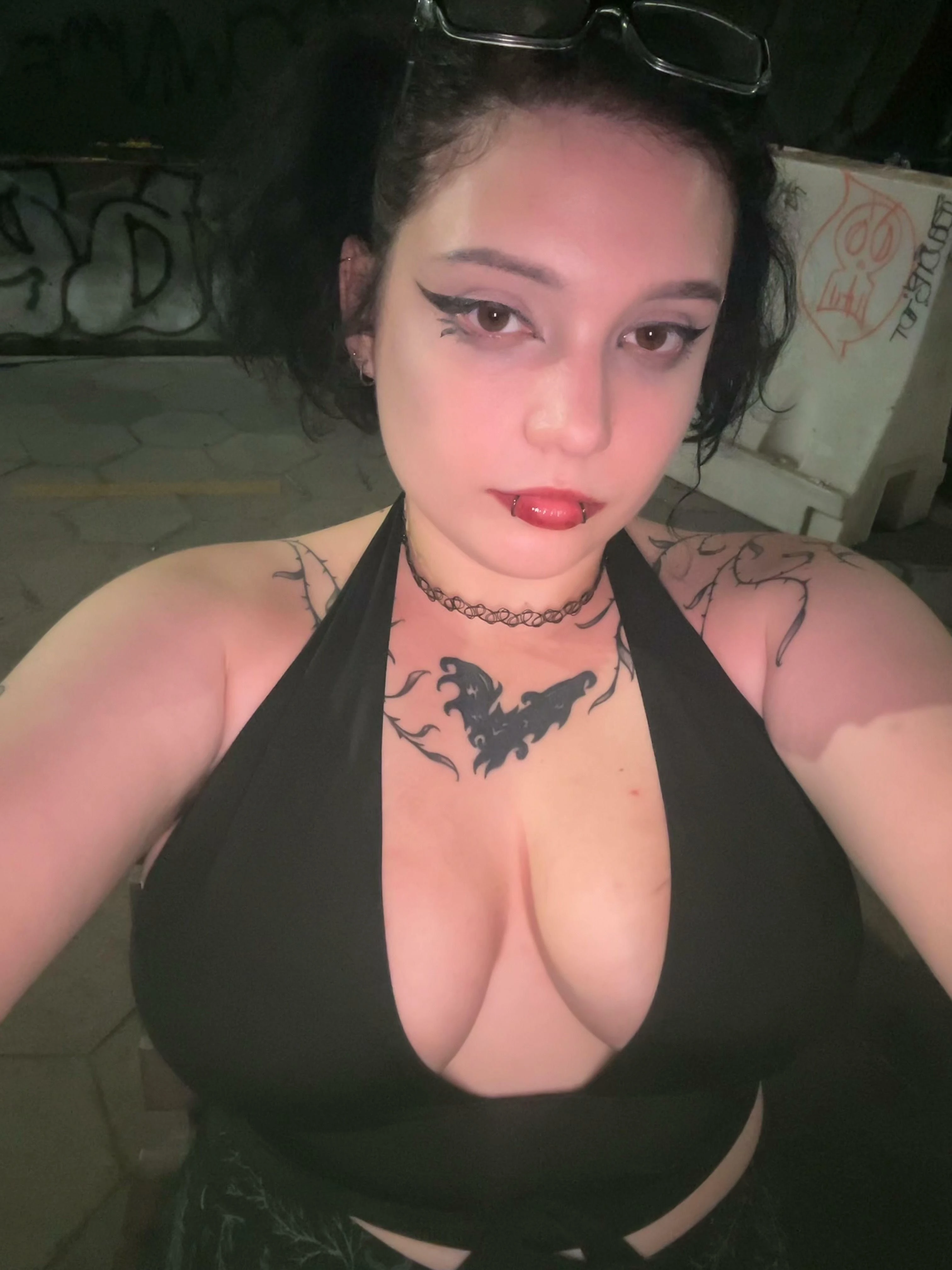 Woman with minimal makeup showing cleavage, sweaty skin visible above neckline