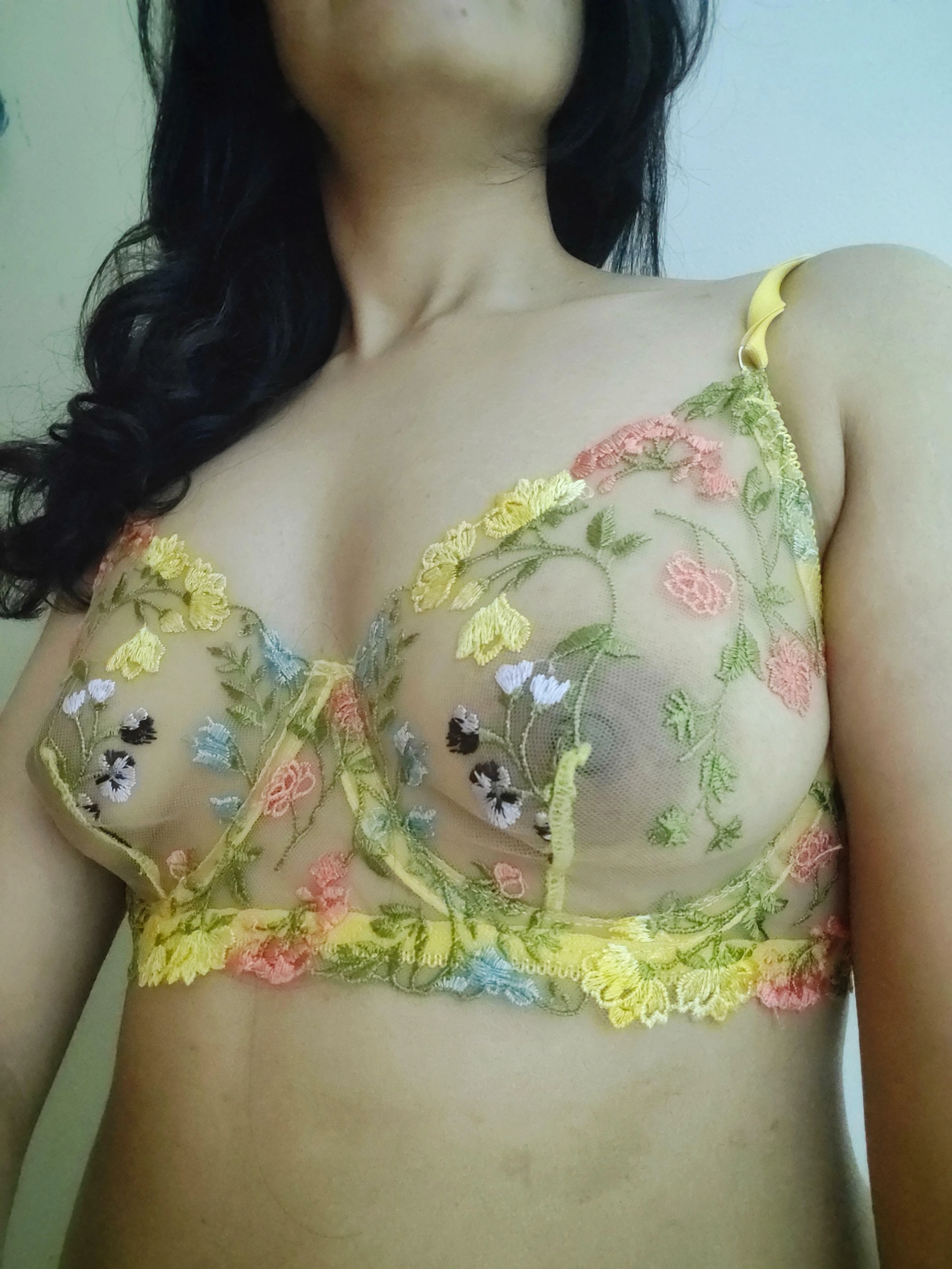 Woman wearing floral lingerie set posed in a pretty, feminine way