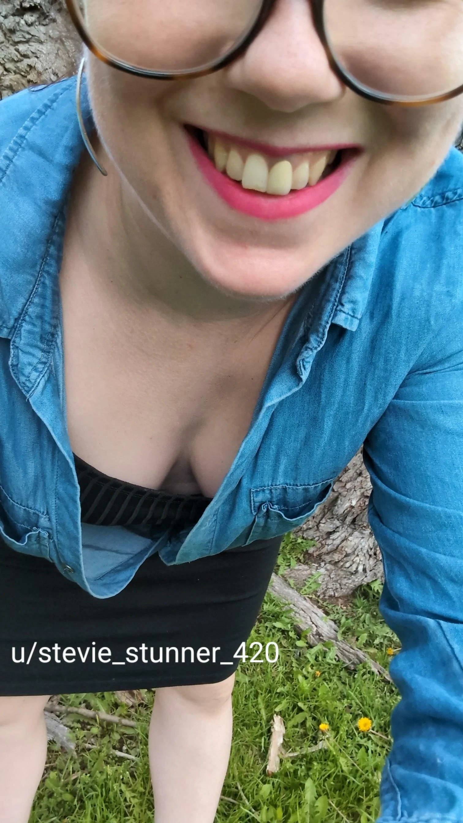 Adult woman in a floral spring outfit showing off her cleavage outdoors