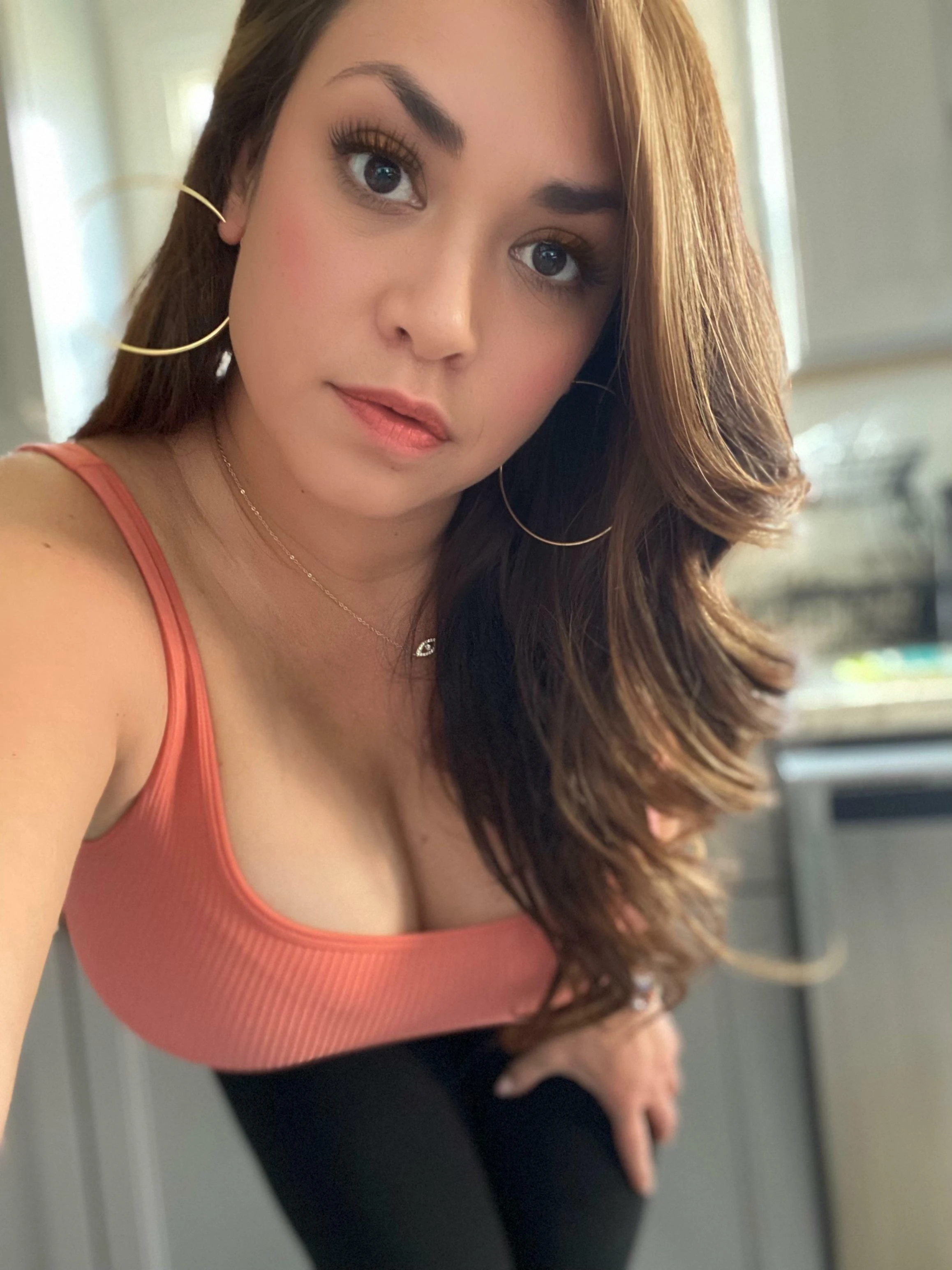 Latina woman posing seductively inviting viewer to join her in bedroom