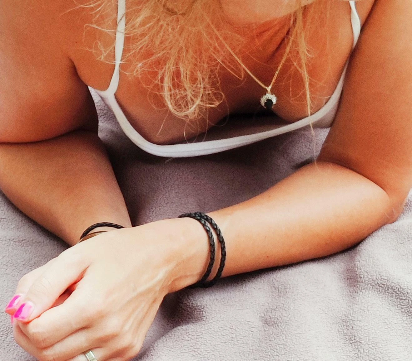 Woman showing cleavage in springtime outdoor setting with blooming flowers