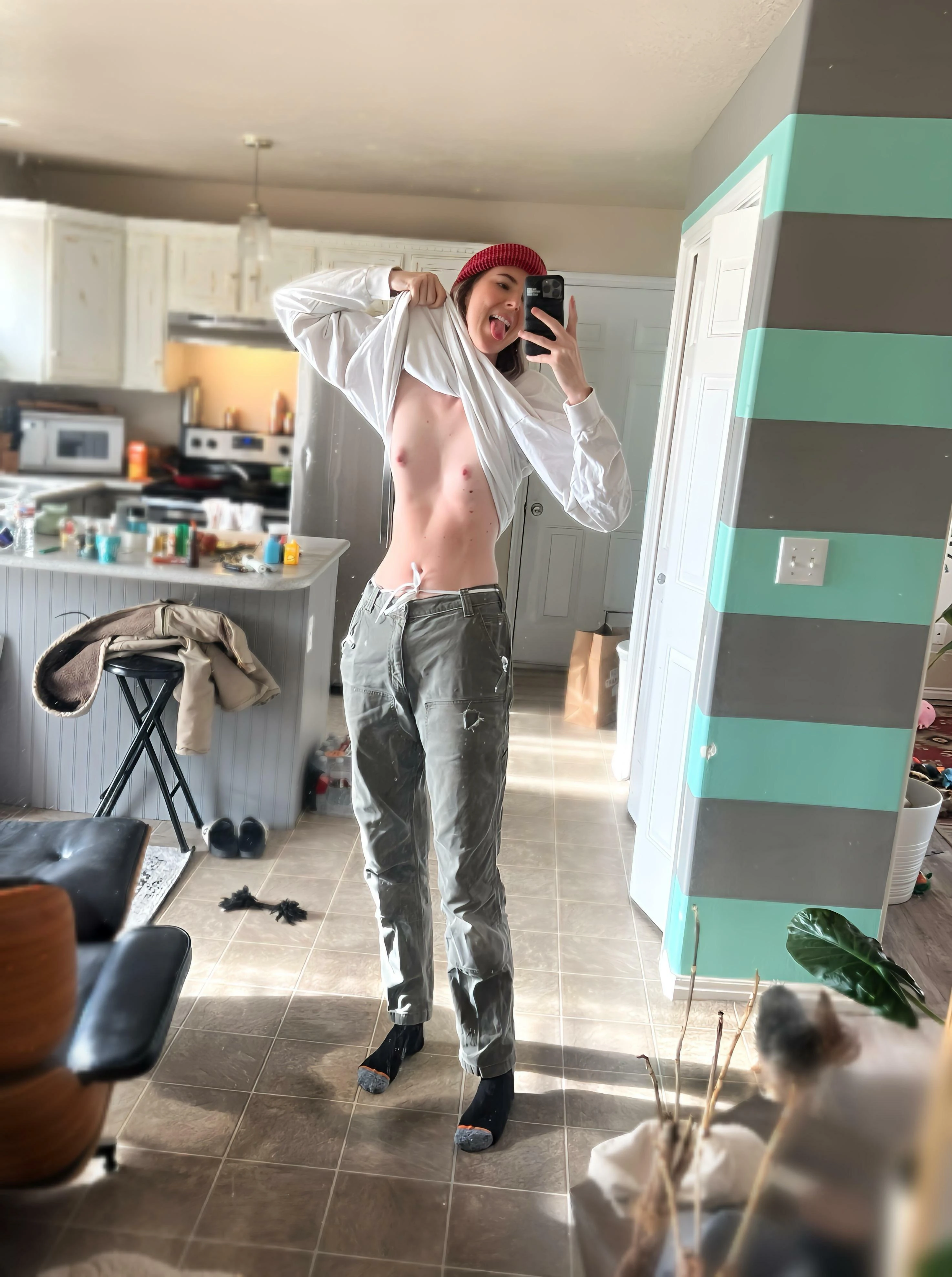 Tall petite woman posing nude showing off her slender adult body