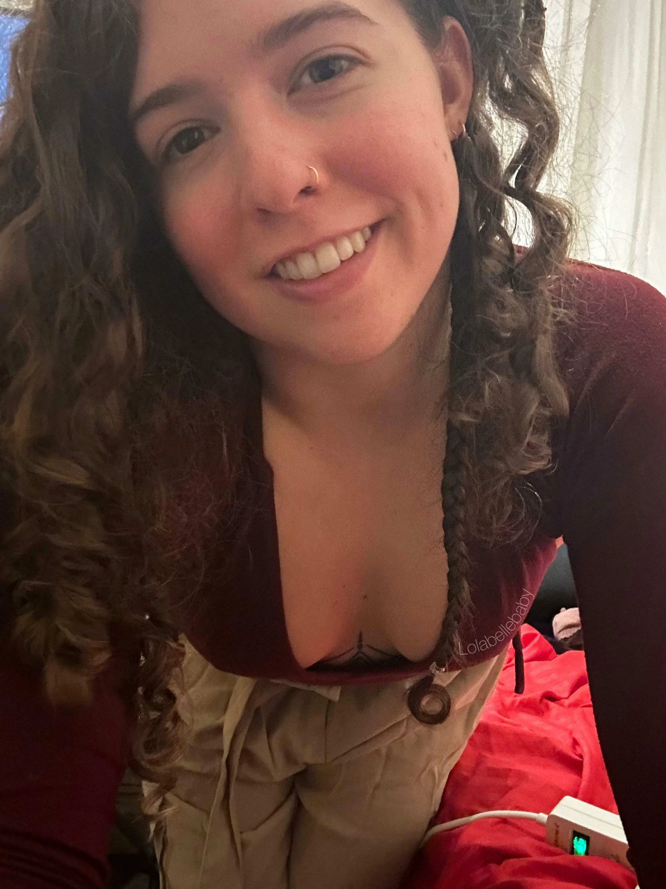 Woman showing off deep cleavage in tight low-cut top